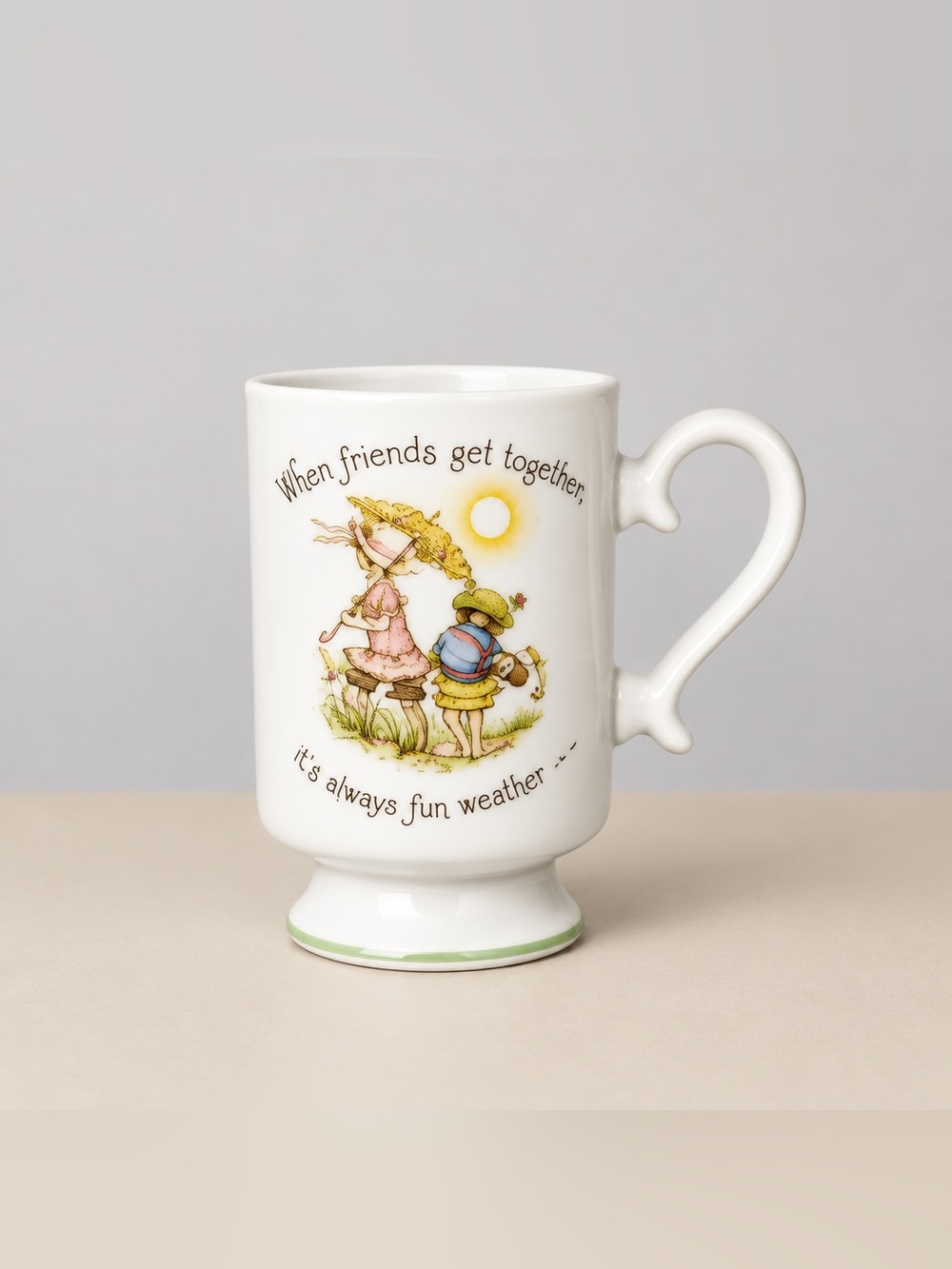 Holly Hobbie vintage porcelain pedestal mug features a When friends get together